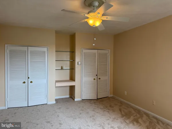 an empty room with closet and a bathroom