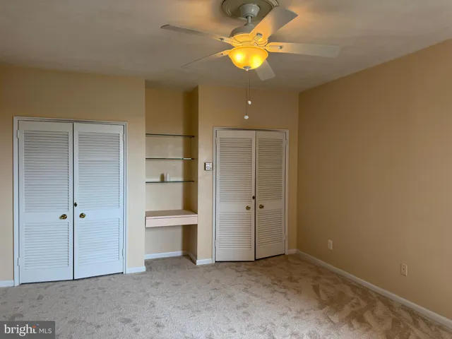 an empty room with closet and a bathroom