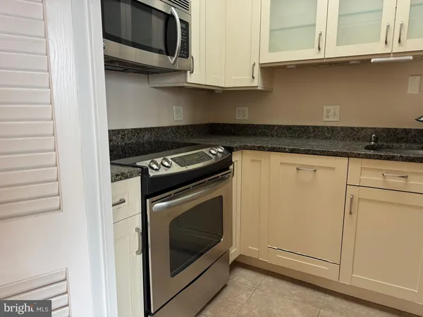 a bathroom with a granite countertop sink a toilet and a mirror