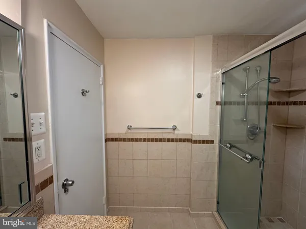 a bathroom with a shower and a mirror