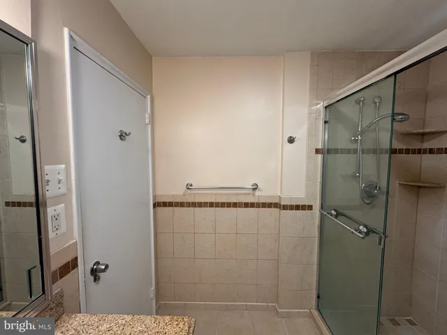 a bathroom with a shower and a mirror