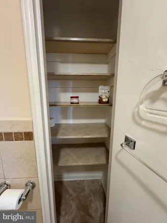 a bathroom with a granite countertop sink a toilet and a mirror