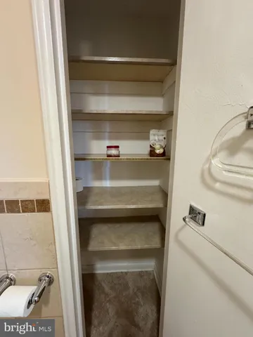 a bathroom with a granite countertop sink a toilet and a mirror
