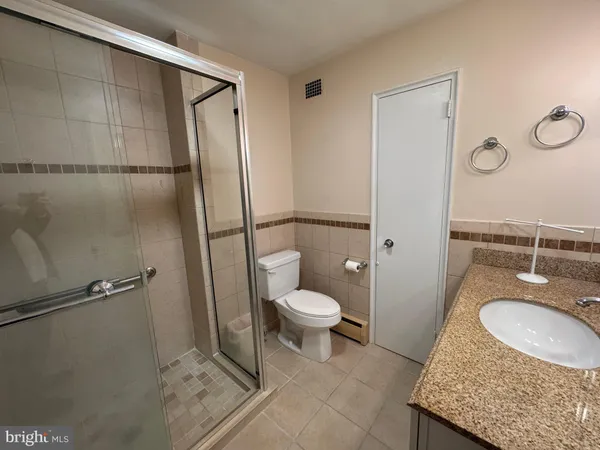a bathroom with a window and a shower