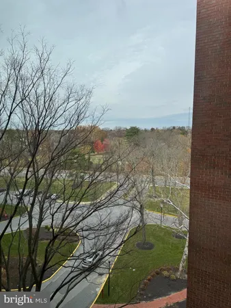 a living room with fireplace furniture and a large window