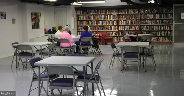 a room with table tennis air hockey table and arcade game machine