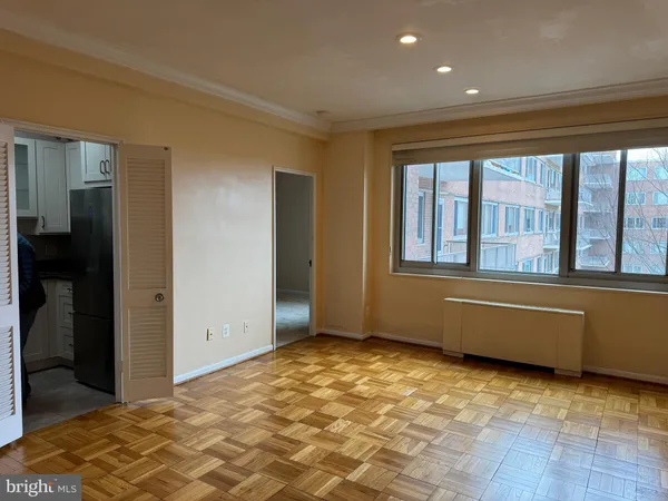 a view of a room that has a bed and a window
