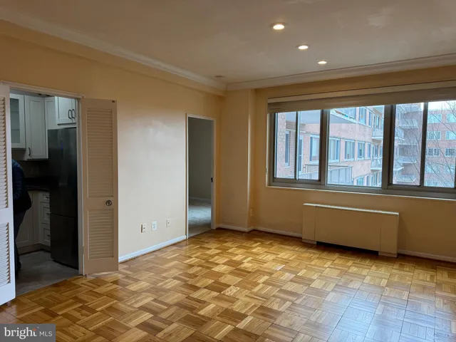 a view of a room that has a bed and a window