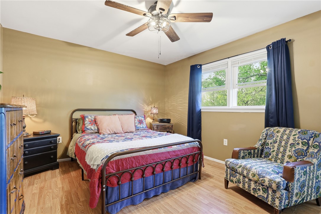 904 New Prospect Church Road Anderson, SC 29625 - Photo 15 of 31 This cozy bedroom features durable laminate flooring and a ceiling fan, perfect for comfortable living.
