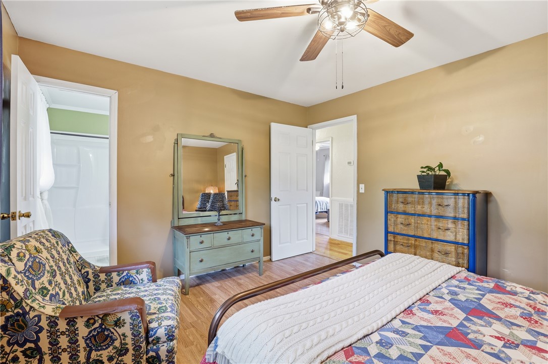 904 New Prospect Church Road Anderson, SC 29625 - Photo 16 of 31 This cozy bedroom offers a welcoming atmosphere with warm tones and hardwood flooring.