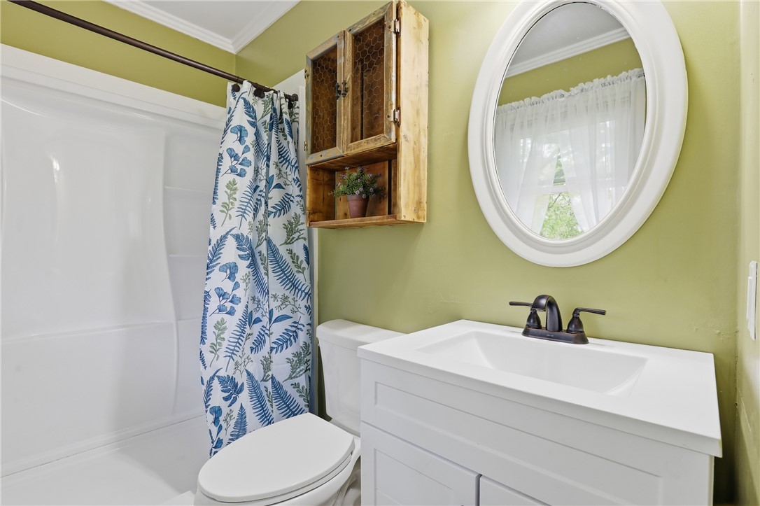 904 New Prospect Church Road Anderson, SC 29625 - Photo 17 of 31 This bright bathroom features a vanity, toilet, and shower, providing a refreshing space.