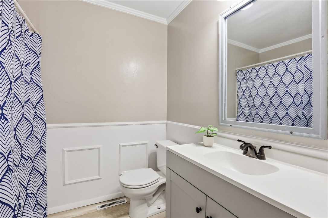 904 New Prospect Church Road Anderson, SC 29625 - Photo 20 of 31 This clean and inviting bathroom features classic wainscoting and a crisp vanity.