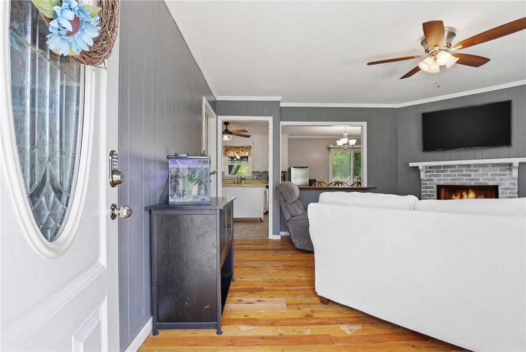 904 New Prospect Church Road Anderson, SC 29625 - Photo 3 of 31 This inviting interior features rich hardwood flooring, a cozy fireplace, and an open concept living space.