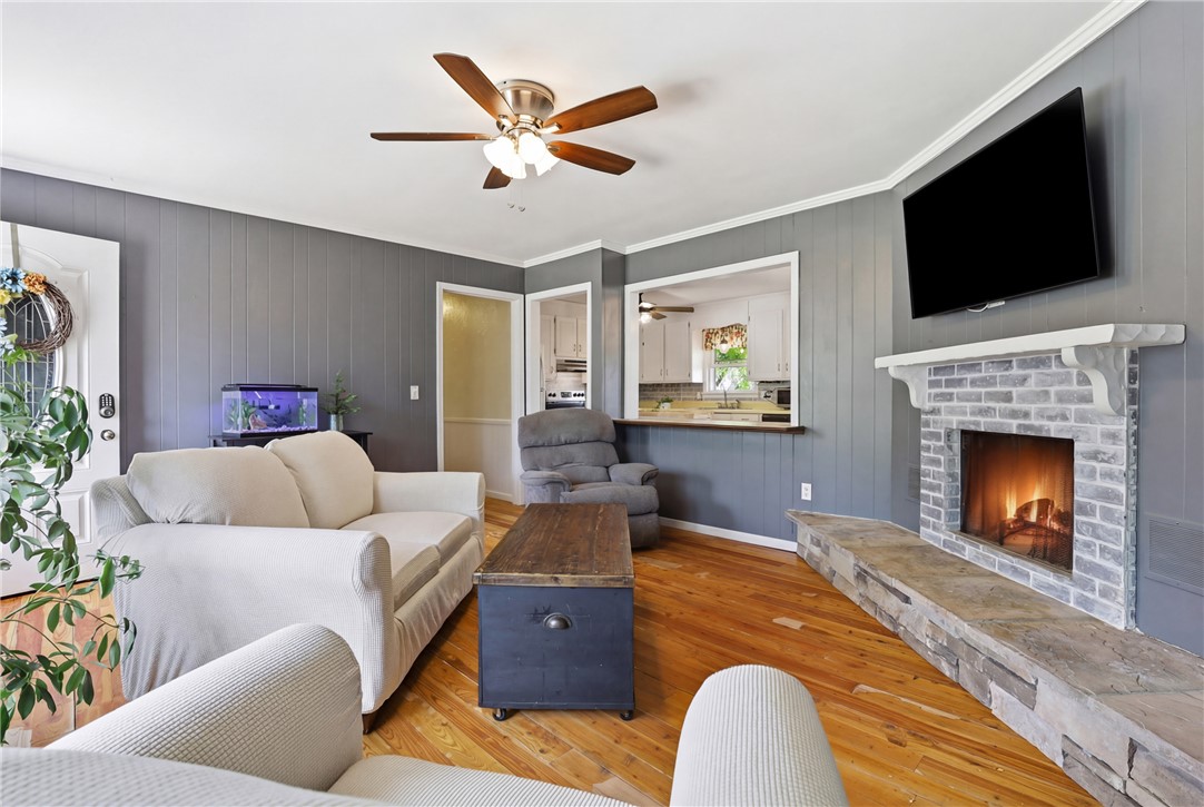904 New Prospect Church Road Anderson, SC 29625 - Photo 5 of 31 This inviting living area features a warm fireplace and rich wood flooring, perfect for cozy gatherings.