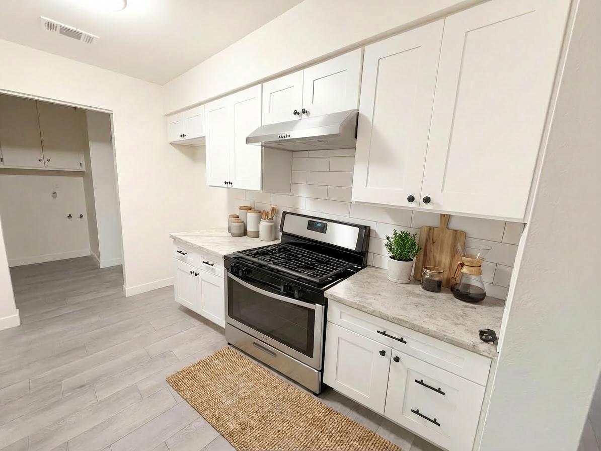 302 Sequoia Drive Exeter, CA 93221 - Photo 8 of 20 a kitchen with granite countertop a stove and a sink