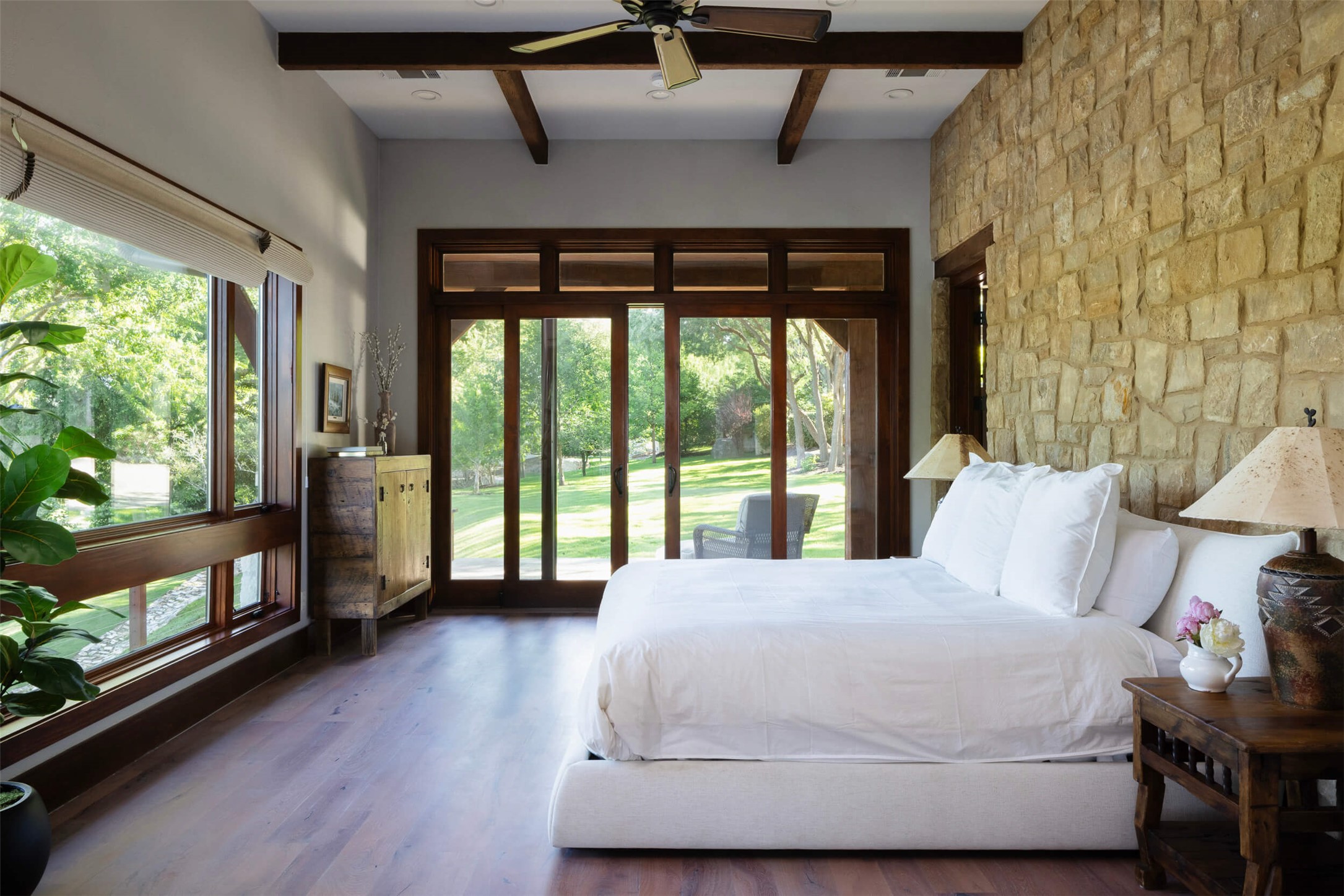 15016 Flat Top Ranch Road Austin, TX 78732 - Photo 24 of 40 Bedroom with beamed ceiling, access to exterior, wood finished floors, and ceiling fan