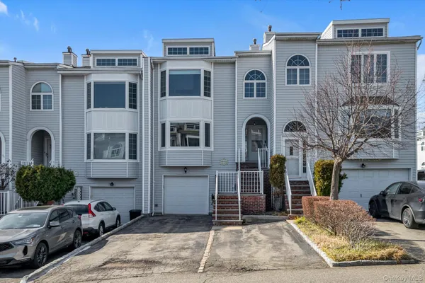 a front view of a house with parking space