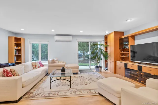 a living room with furniture large window and a flat screen tv