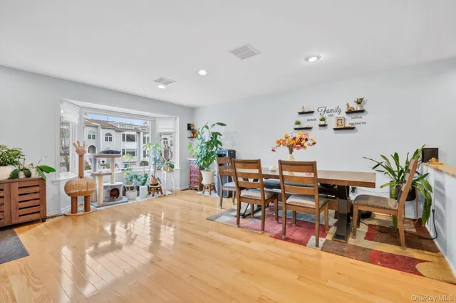 a dining room with furniture and wooden floor