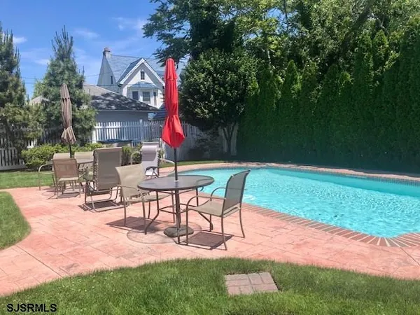 a view of a backyard with sitting area