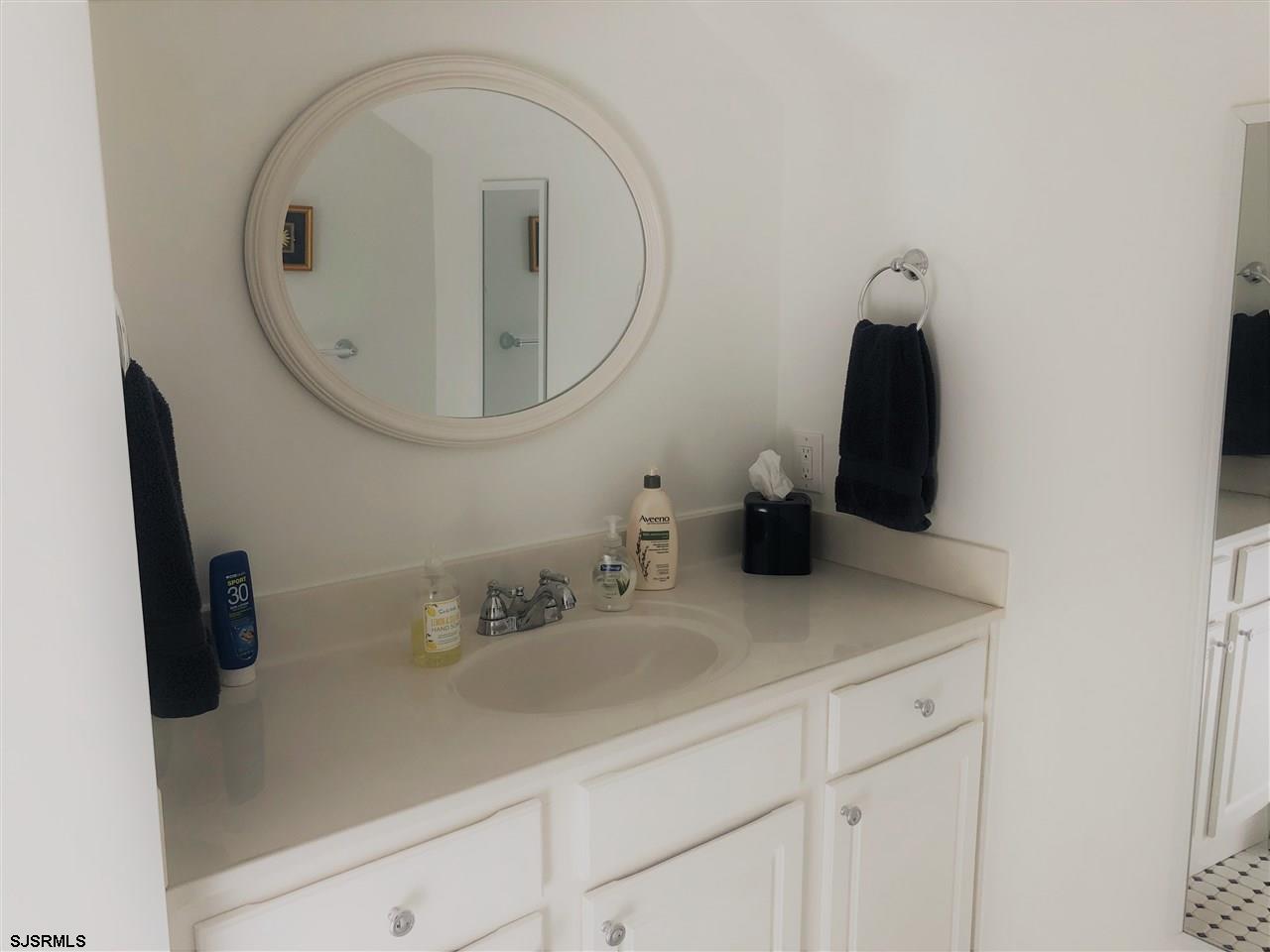 5806 Ventnor Avenue Ventnor City, NJ 08406 - Photo 17 of 25 a bathroom with a sink and a mirror