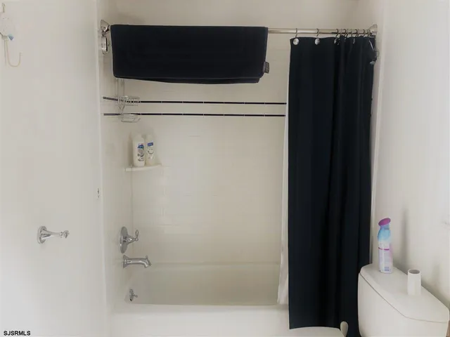 a bathroom with a shower and a toilet