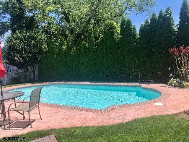 a view of a backyard with a table and chairs