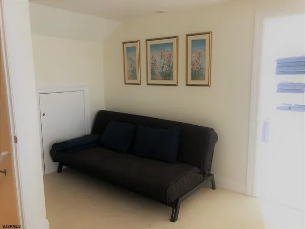 a living room with furniture and a cabinet