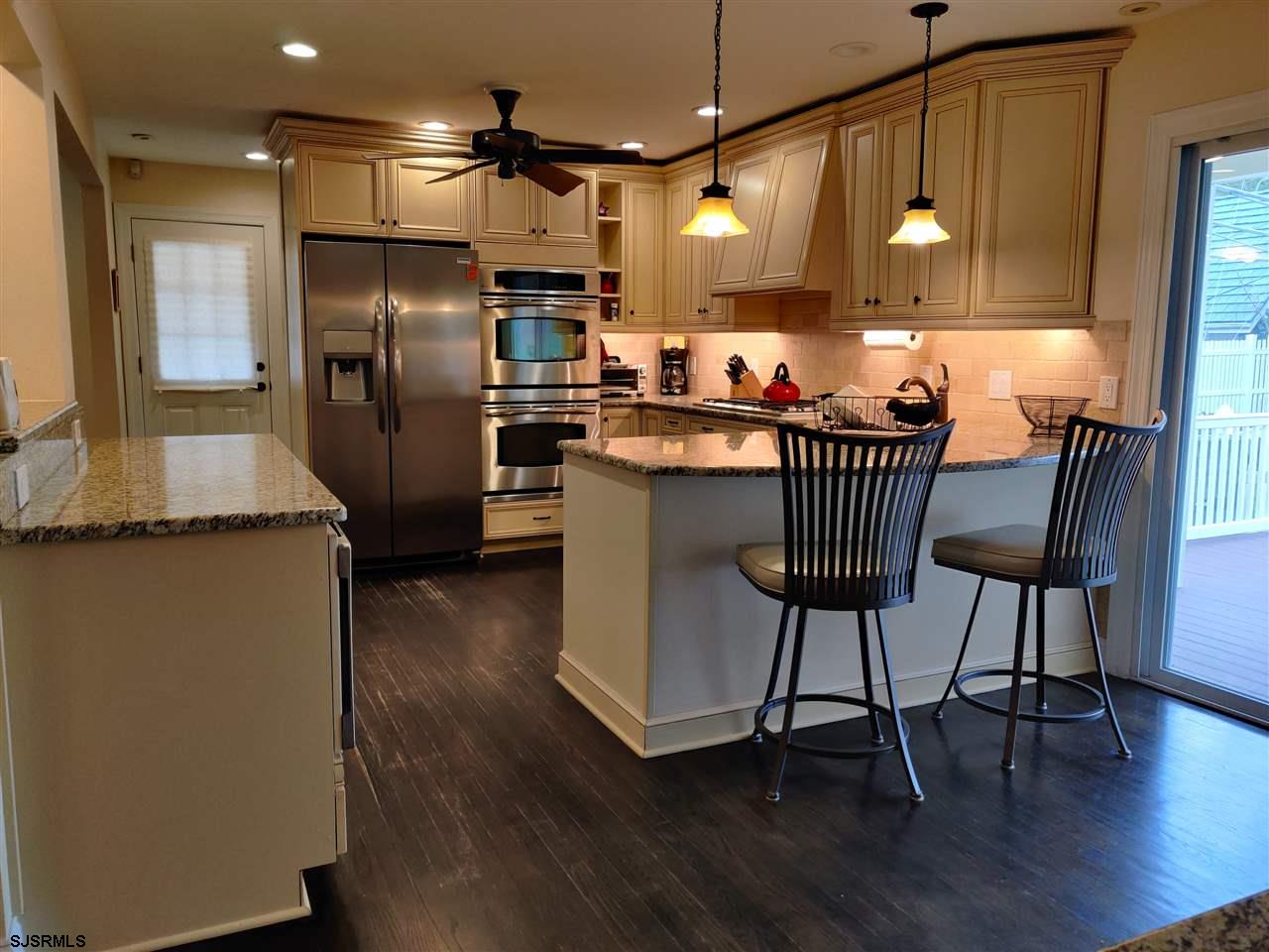 5806 Ventnor Avenue Ventnor City, NJ 08406 - Photo 8 of 25 a kitchen with stainless steel appliances granite countertop a refrigerator a sink a stove and a wooden floors