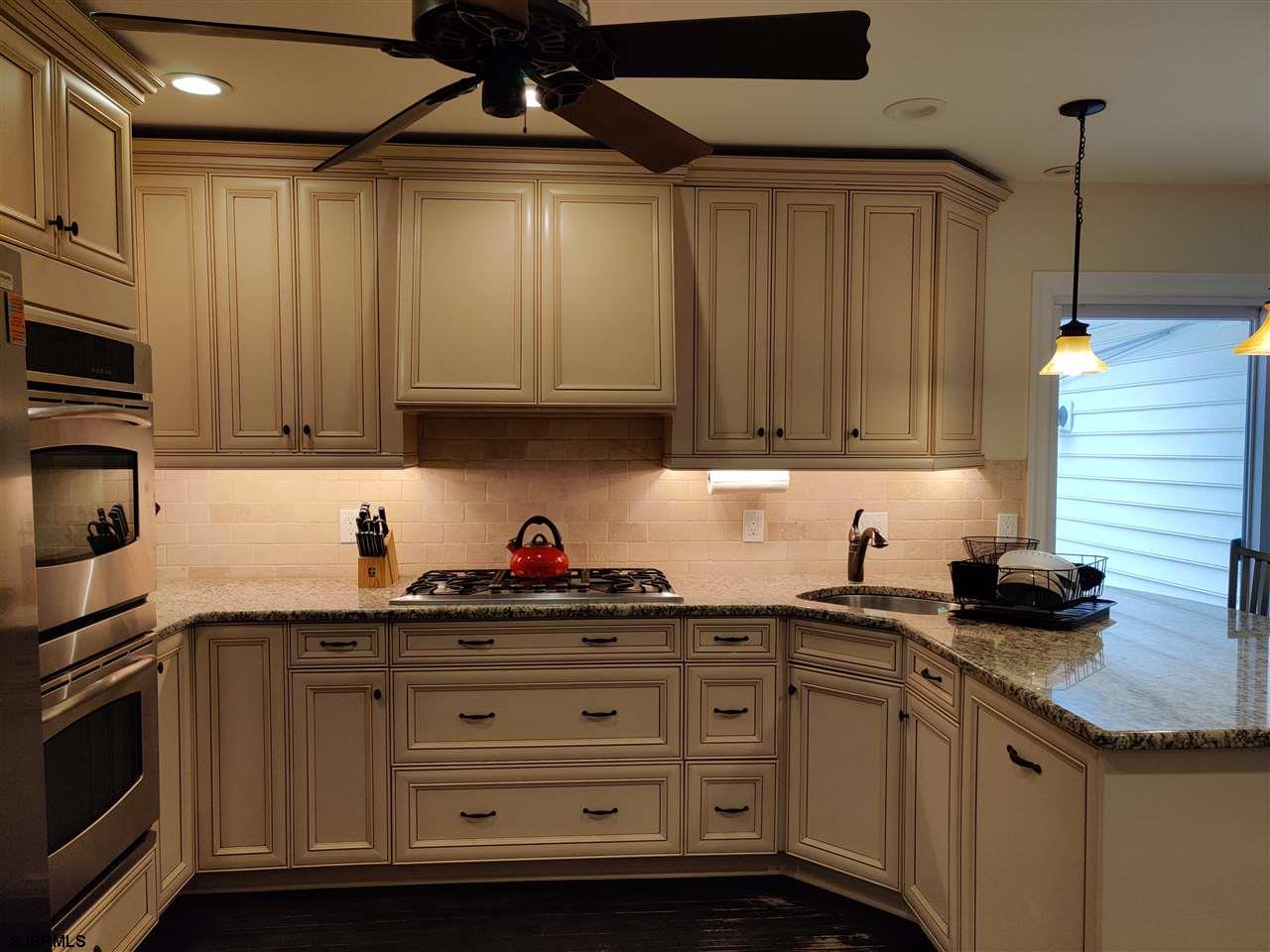 5806 Ventnor Avenue Ventnor City, NJ 08406 - Photo 9 of 25 a kitchen with stainless steel appliances granite countertop a sink a stove and a microwave