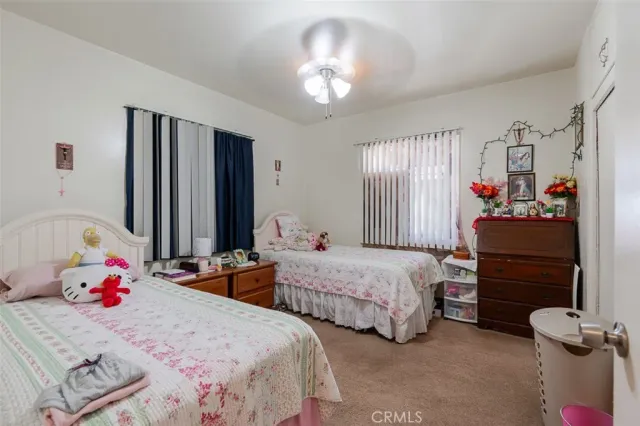 a bedroom with two beds and a dresser