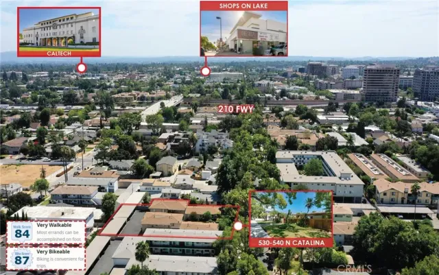 an aerial view of residential houses with outdoor space and parking