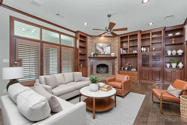 a living room with furniture a fireplace and a large window