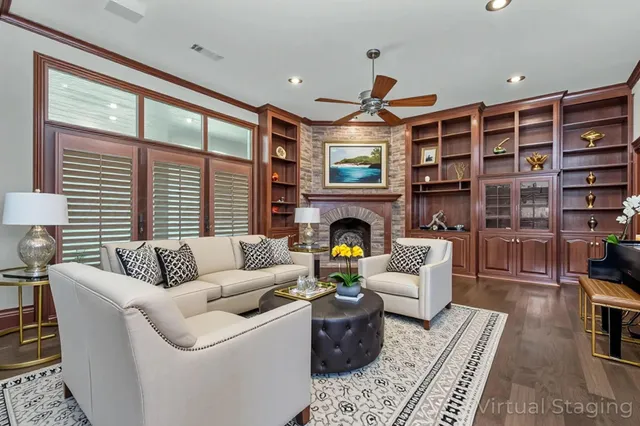 a living room with furniture a fireplace and a large window