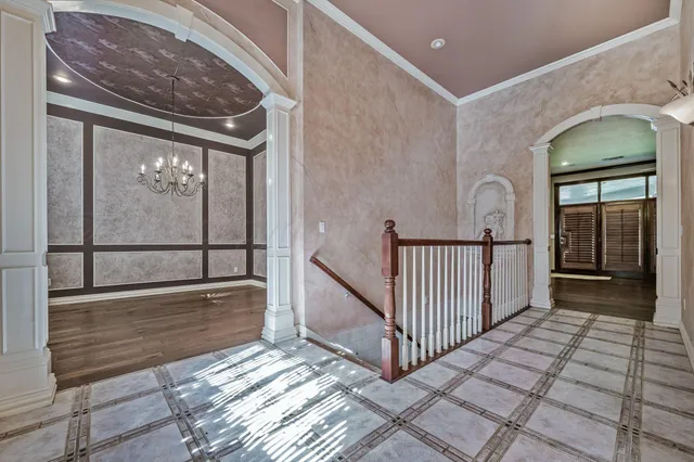 a view of a hallway with wooden floor and a floor to ceiling window