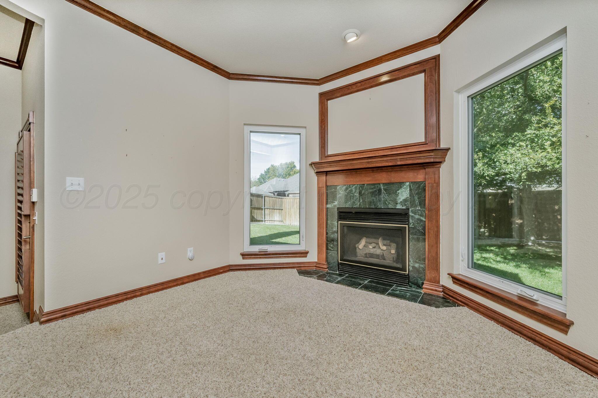 7408 Park Ridge Drive Amarillo, TX 79119 - Photo 24 of 51 a view of an empty room with a fireplace and a window