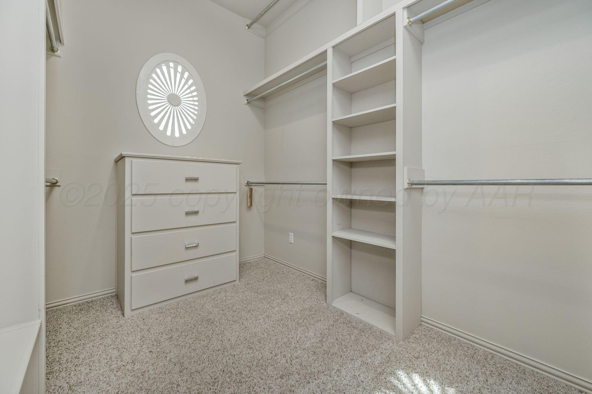 7408 Park Ridge Drive Amarillo, TX 79119 - Photo 27 of 51 a view of walk in closet with empty racks