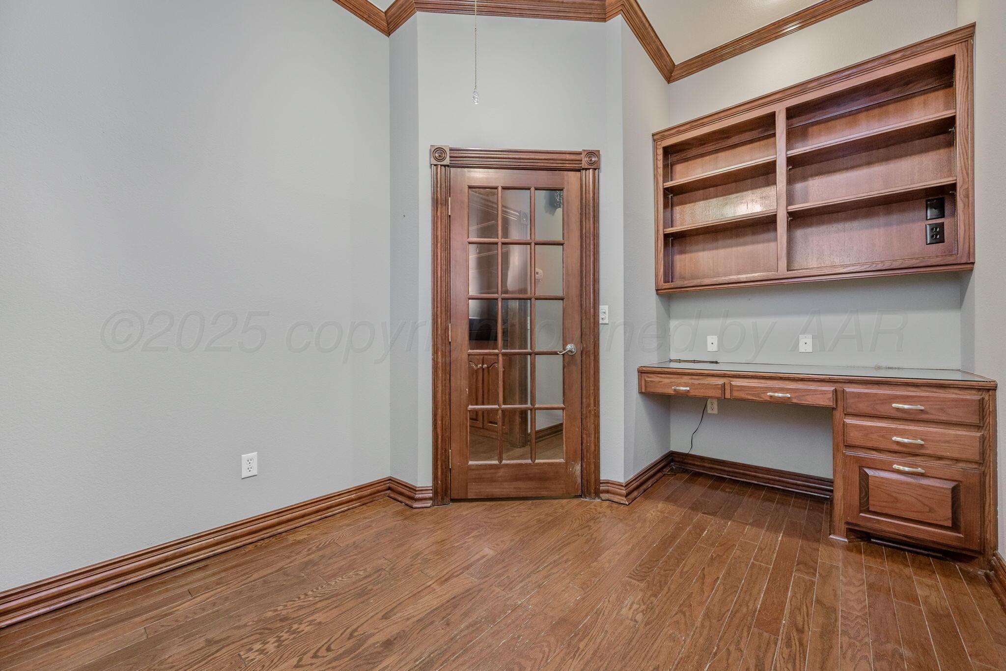 7408 Park Ridge Drive Amarillo, TX 79119 - Photo 28 of 51 a view of an empty room with a window and wooden floor