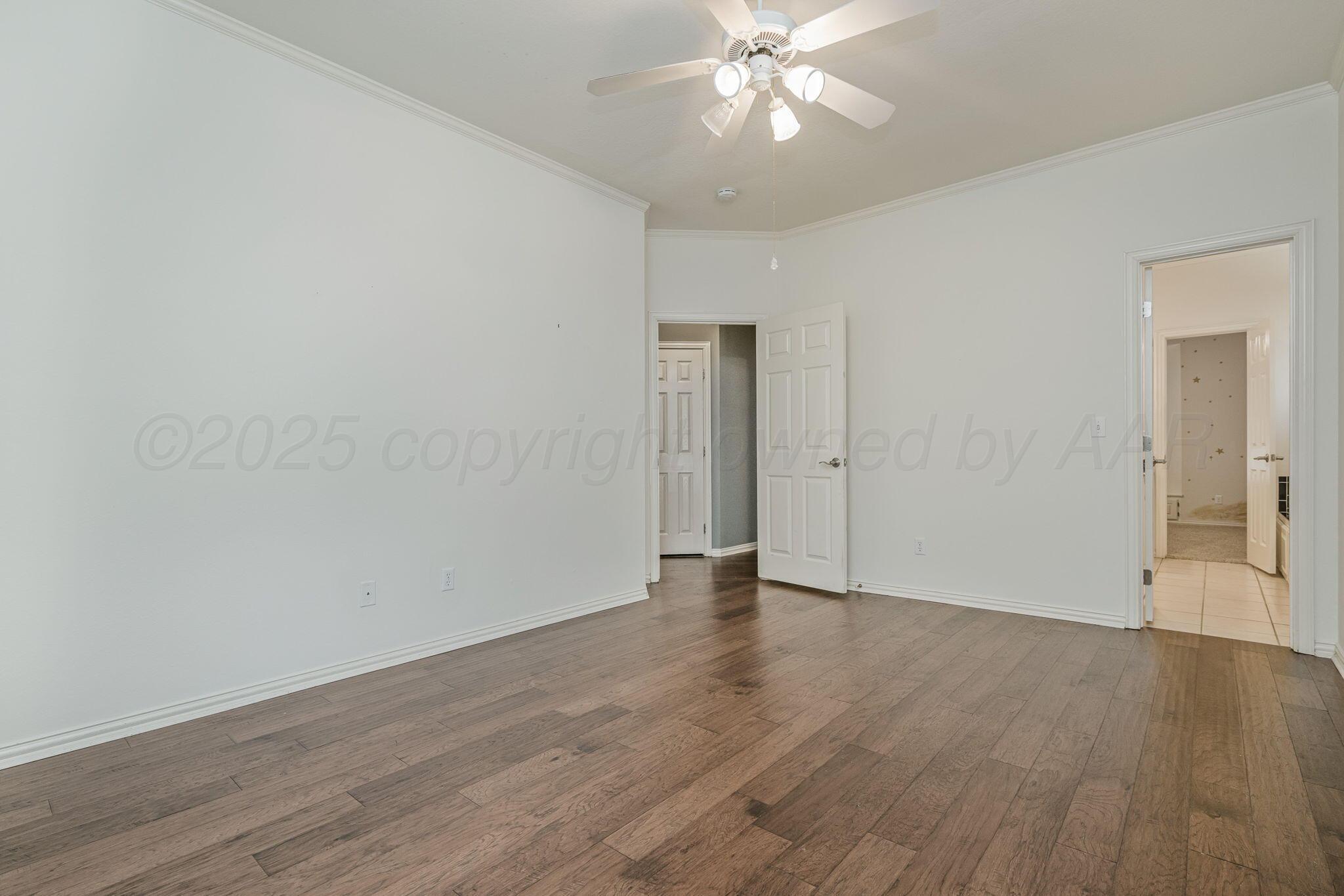 7408 Park Ridge Drive Amarillo, TX 79119 - Photo 30 of 51 a view of an empty room with wooden floor