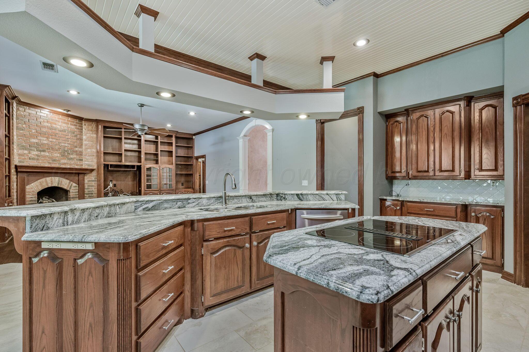 7408 Park Ridge Drive Amarillo, TX 79119 - Photo 3 of 51 a kitchen with granite countertop a sink and a wooden floor