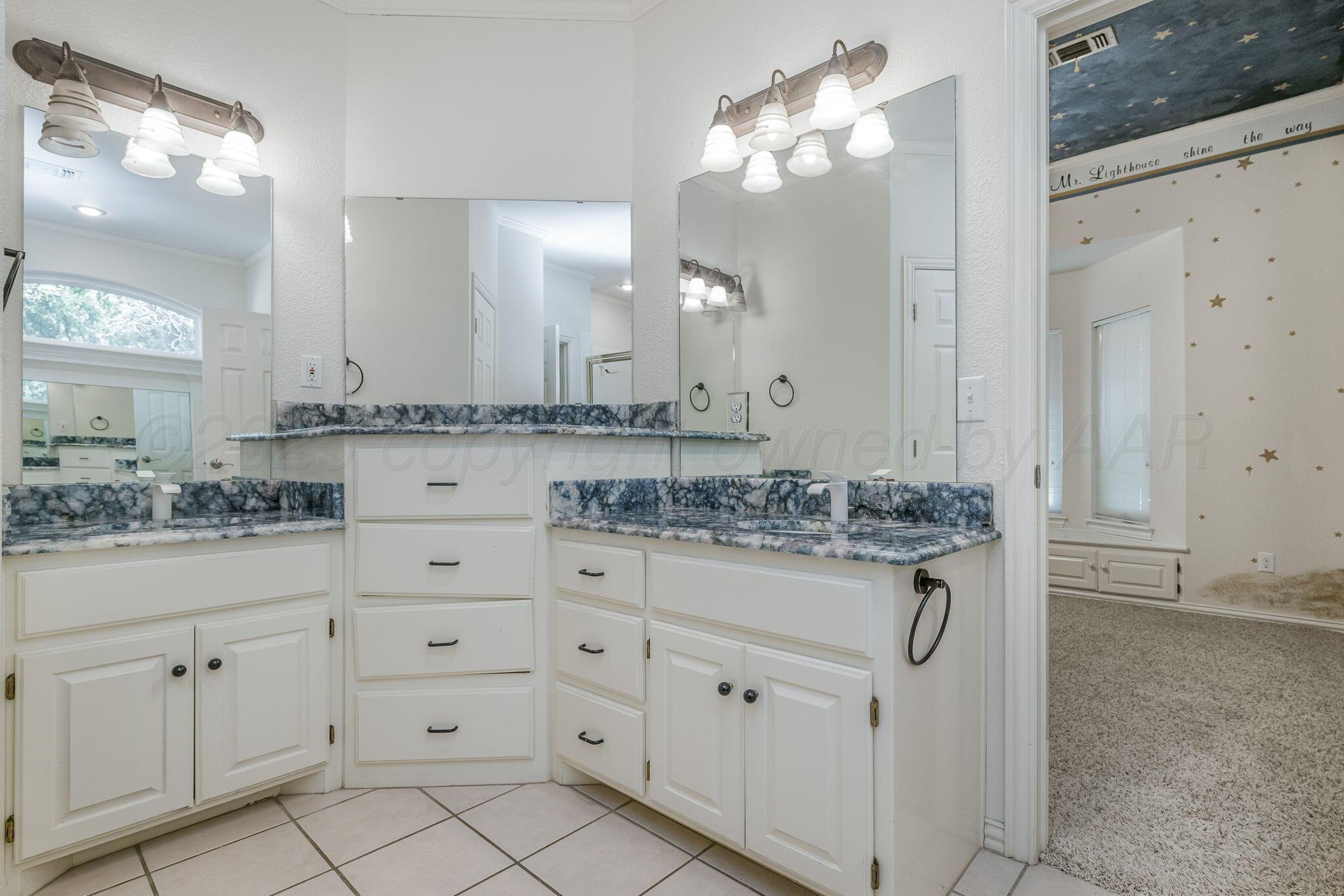 7408 Park Ridge Drive Amarillo, TX 79119 - Photo 34 of 51 a bathroom with a granite countertop sink and a mirror