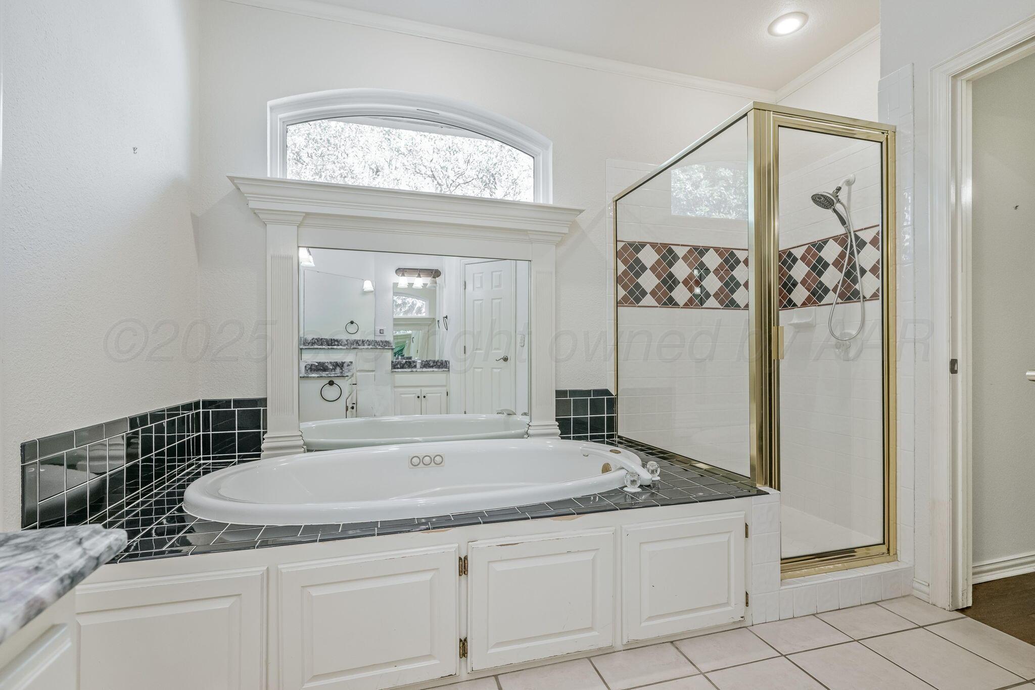 7408 Park Ridge Drive Amarillo, TX 79119 - Photo 35 of 51 a bathroom with a granite countertop sink mirror and vanity