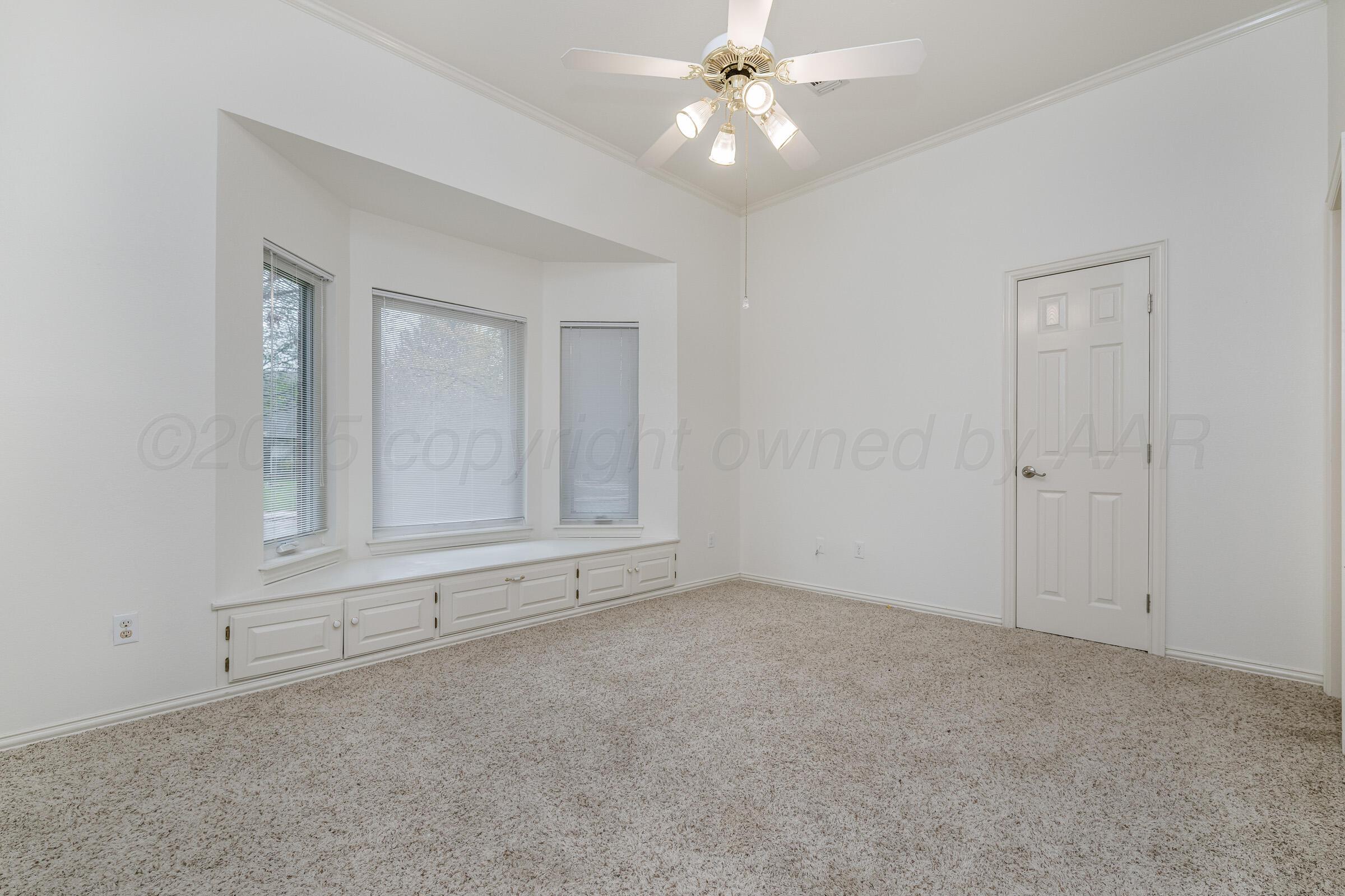 7408 Park Ridge Drive Amarillo, TX 79119 - Photo 36 of 51 an empty room with chandelier fan