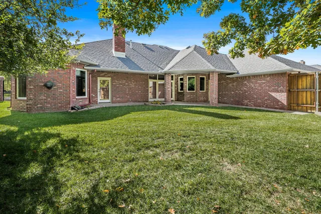 a front view of a house with a garden and yard