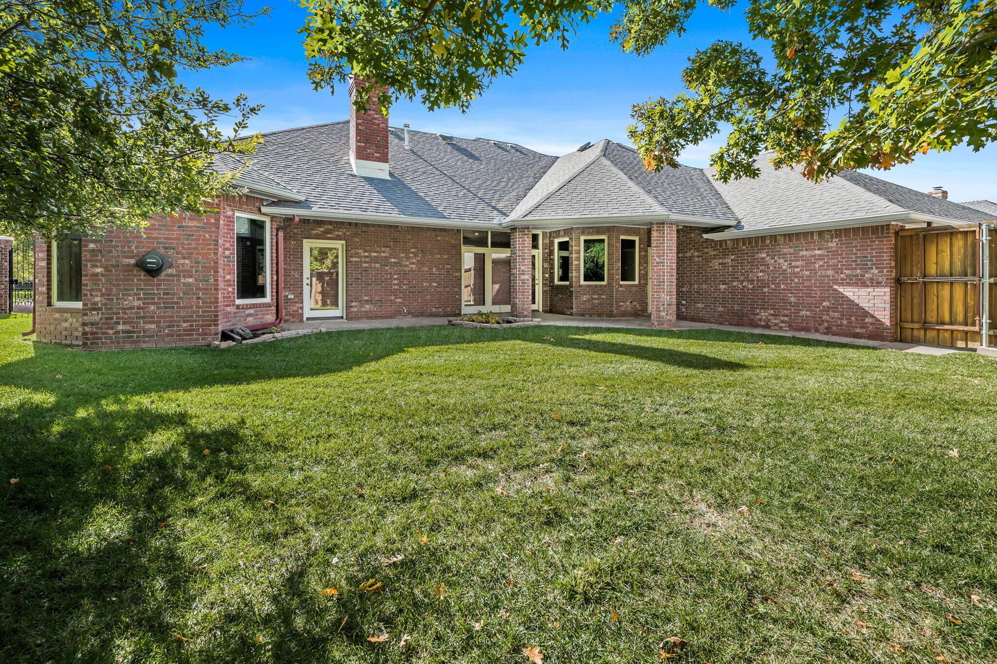 7408 Park Ridge Drive Amarillo, TX 79119 - Photo 48 of 51 a front view of a house with a garden and yard