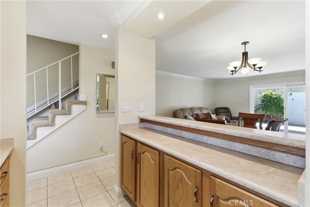 3342 Bradbury Road, Unit 20 Los Alamitos, CA 90720 - Photo 13 of 32 a kitchen with stainless steel appliances kitchen island granite countertop a sink and cabinets