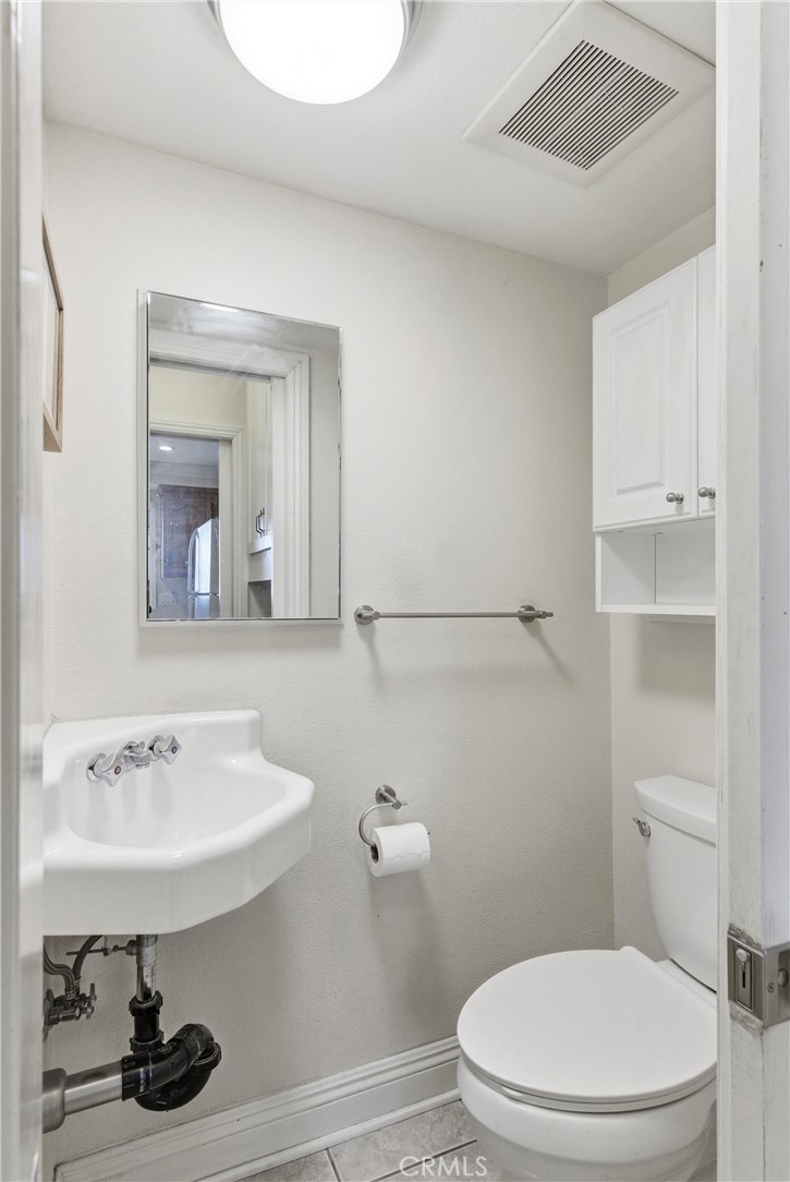3342 Bradbury Road, Unit 20 Los Alamitos, CA 90720 - Photo 15 of 32 a bathroom with a sink a toilet and vanity