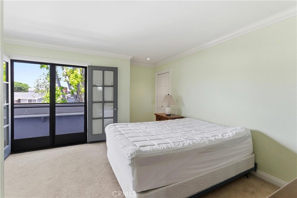 3342 Bradbury Road, Unit 20 Los Alamitos, CA 90720 - Photo 17 of 32 a bedroom with a bed and wooden floor