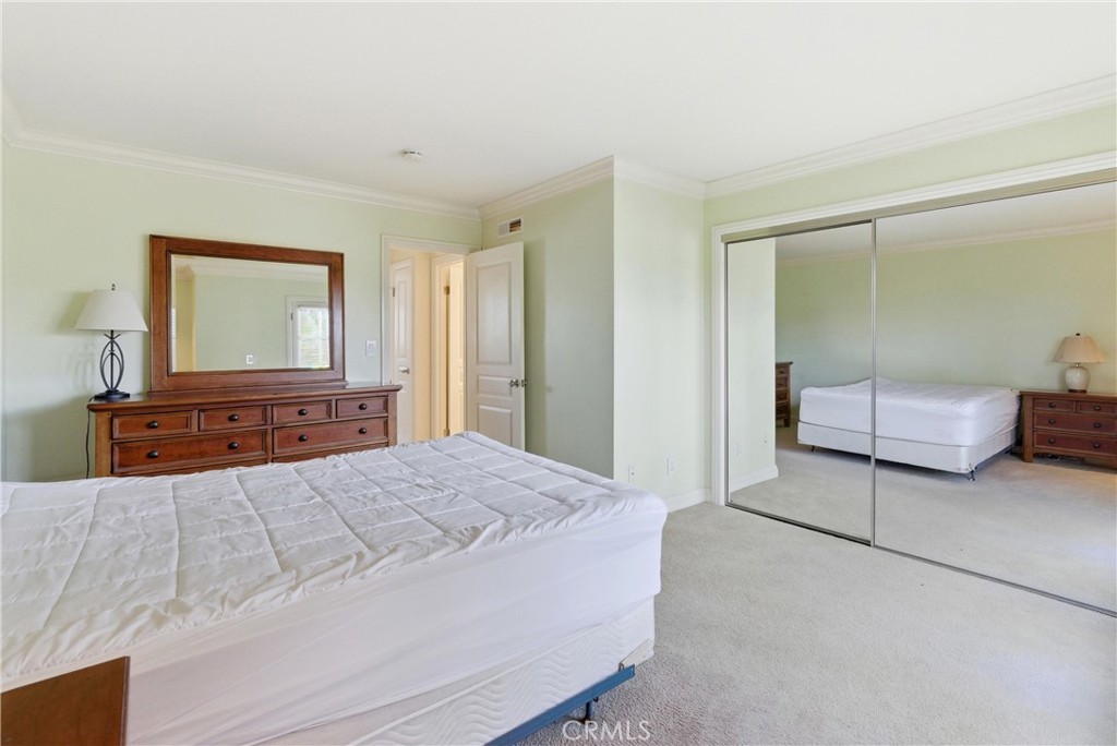 3342 Bradbury Road, Unit 20 Los Alamitos, CA 90720 - Photo 20 of 32 a bedroom with a bed and a large mirror