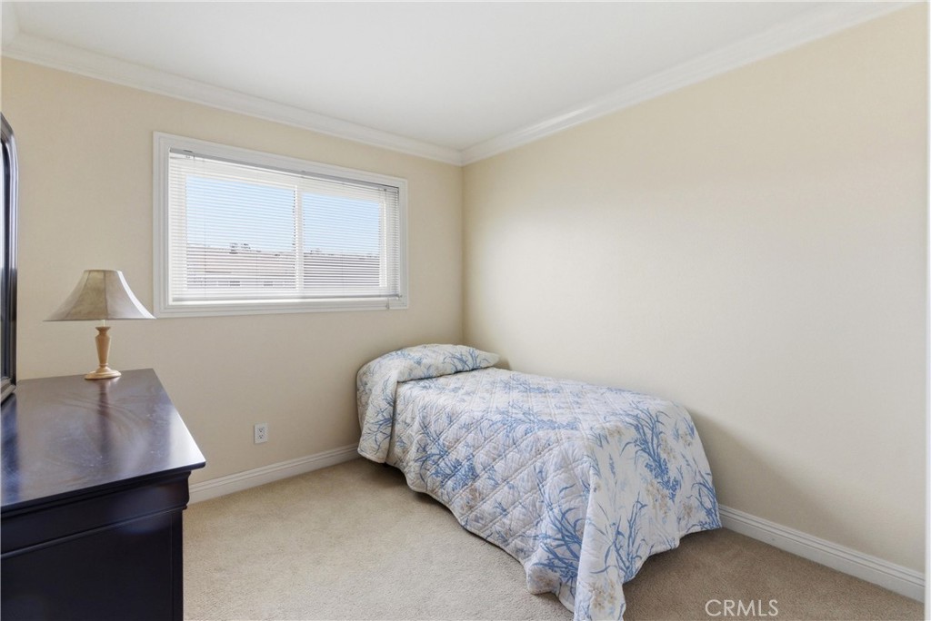 3342 Bradbury Road, Unit 20 Los Alamitos, CA 90720 - Photo 24 of 32 a bed sitting in a bedroom next to a window